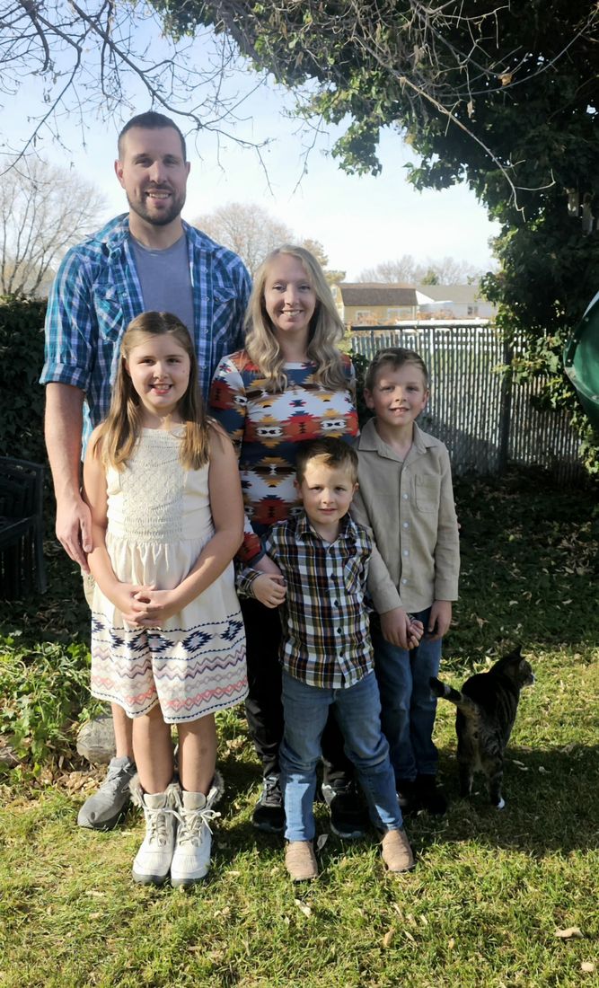 Matthew and Alena Little with their daughter and two sons in the backyard